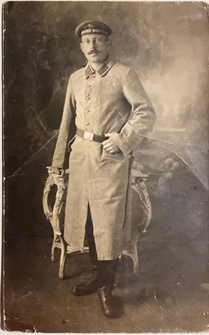 Hofmann wearing a dark greatcoat in a cropped portrait.