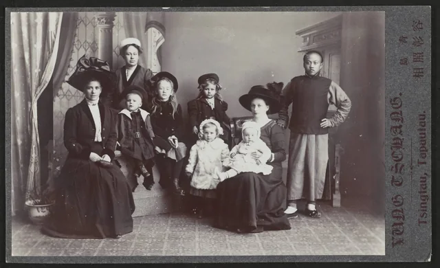 Nine people in a studio group portrait on a Yung Tschang and Co. mount.