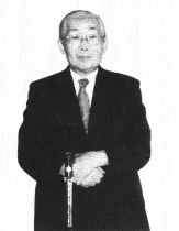 Older Yoshiharu Nakahara in a formal seated portrait.